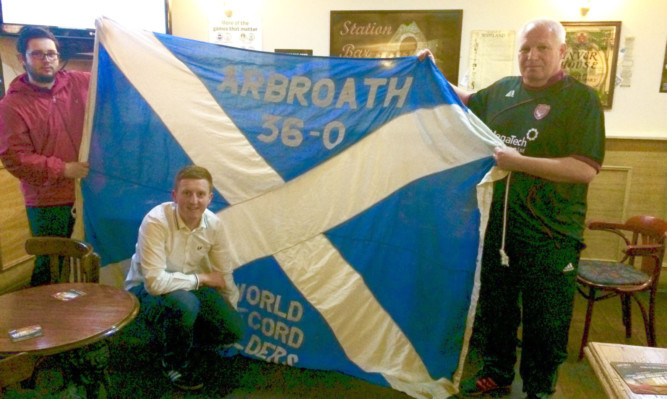 Safe home: from left, Gareth, Ryan and Sye with the treasured flag. Below, the long route home. Left, the hostesses with the flag in Canada.