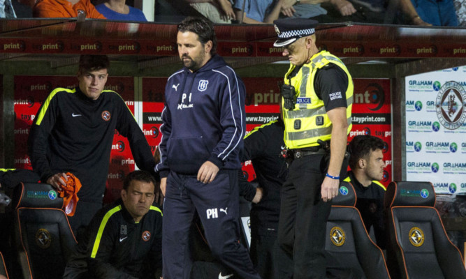 Dundee manager Paul Hartley heads to the stand.