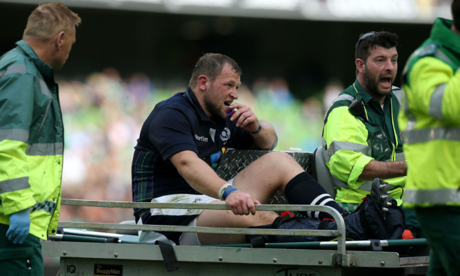 Scotlands Ryan Grant is stretchered off the pitch.