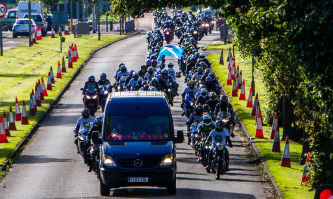 The convoy of bikers follows the van carrying Mr Lawsons body as it is taken from Dundee to Arbroath last week.