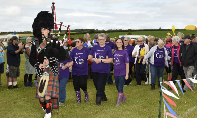 Piper Ben Anderson led the cancer survivors for an emotional lap of applause before the start of the Kirriemuir Relay for Life.