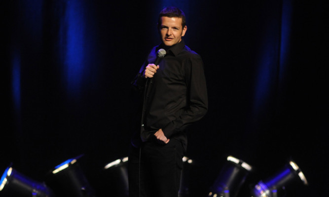 Kevin Bridges on stage at the Alhambra.