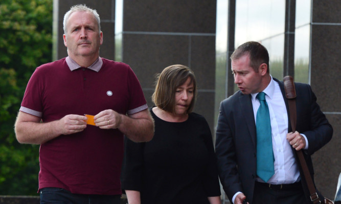 Jacqueline and Matthew McQuade, who lost Jacqueline's parents Jack and Lorraine Sweeney and their daughter Erin, arrive at the hearing in Glasgow with their lawyer.