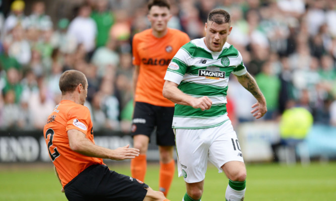 Celtic's Anthony Stokes is tackled by Sean Dillon.