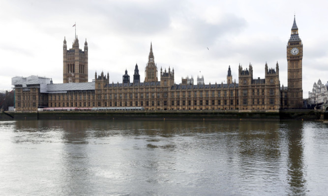 The Palace of Westminster and Houses of Parliament, London, as there are 100 days to the general election and the parties wheeled out their big guns for a campaign which appears to be shaping up as "wealth versus health". PRESS ASSOCIATION Photo. Picture date: Tuesday January 27, 2015. David Cameron promised he would act "within the first few days" of forming a new government to cut the annual benefits cap introduced by the coalition from £26,000 to £23,000 per household, using the £135 million savings generated to help fund three million apprenticeships by 2020. See PA story POLITICS Election. Photo credit should read: Jonathan Brady/PA Wire