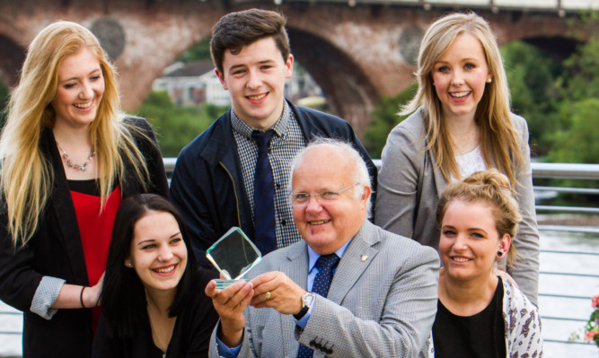 Councillor Bob Band shows one of the awards to Perth and Kinross modern apprentices. From left: Ellis Melloy, Keeley Hawkins, Ross Rattray, Jennifer McGregor and Miriam Patterson, front.