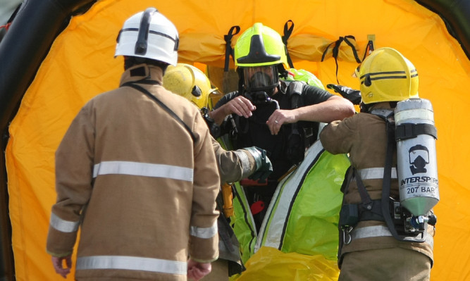 Firefighters donned protective suits to deal with Tuesday's leak.