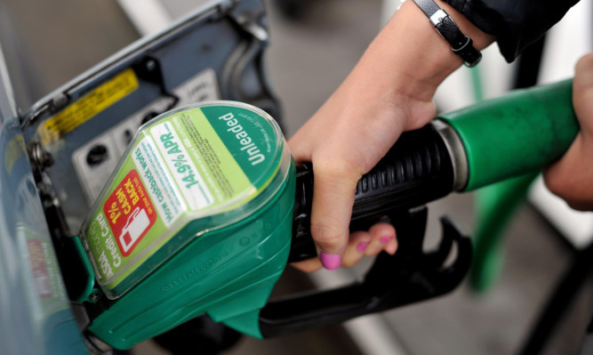 A view of a person using an Asda petrol pump in Chelmsford, Essex. PRESS ASSOCIATION Photo. Picture date: Thursday August 15, 2013. Photo credit should read: Nick Ansell/PA Wire