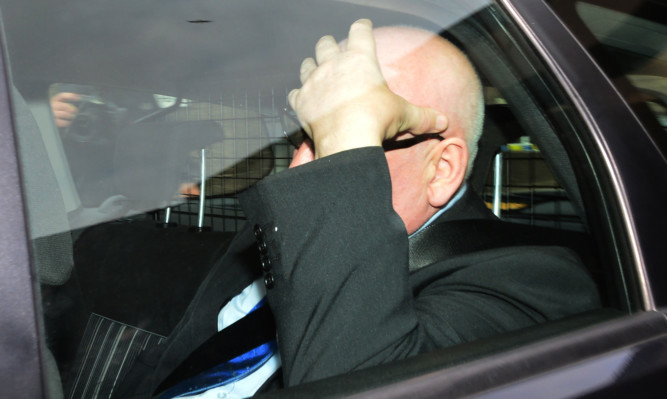 Harry Clarke leaving court after giving evidence during inquiry.