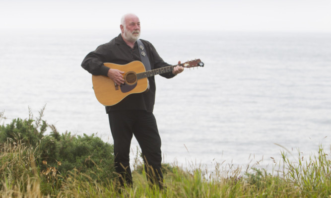 Wave of emotion: Mr Ramsay at the cliffs at Arbroath.