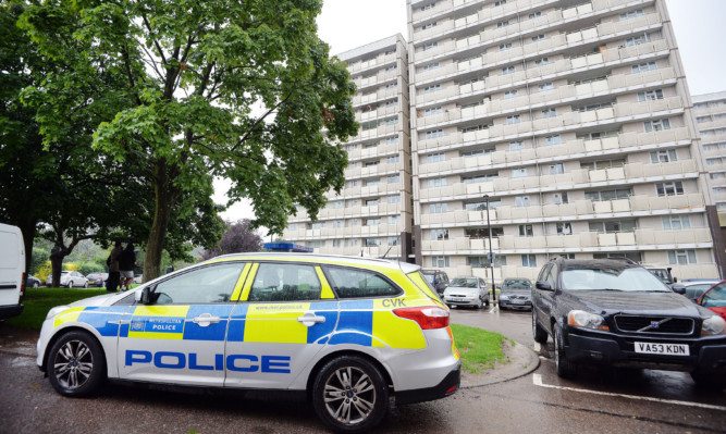 A police car parked outside Picardy House in Cedar Road, Enfield, where police shot a man dead after they were called to reports that a person armed with a firearm was making threats to kill.