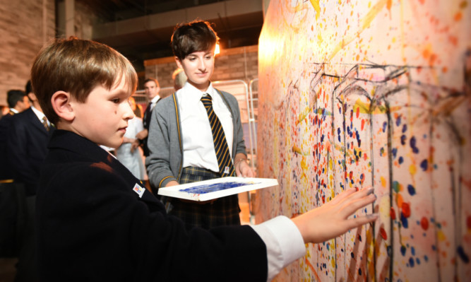 Visitors were encouraged to add their mark to a mural being created by the art department. Pupils Hamish Lawrie and Rachael Chalmers get involved.