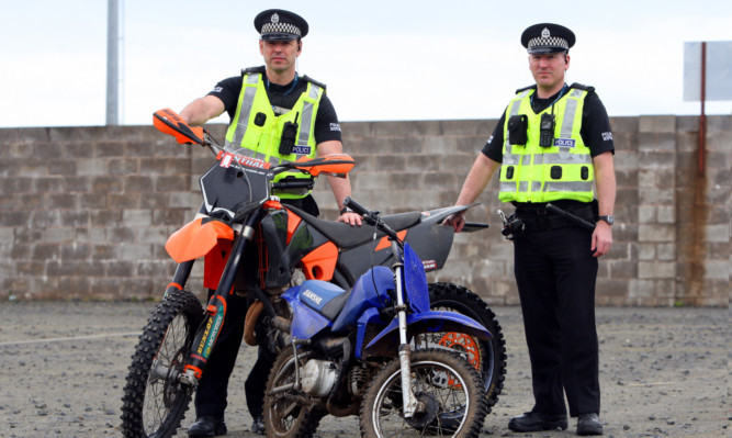 PCs Mark McCulloch and Steven Black with off-road bikes confiscated during Operation Fireblade.