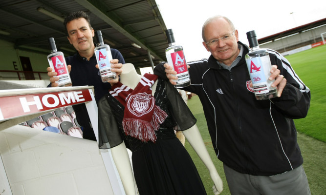 With the Lorraine Kelly dress and special gin and vodka are Arbroath FC Chairman John Christison (right) and Arbikie Highland Estate director John Stirling.