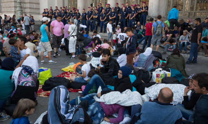 A security line prevents the migrants getting into Budapest's main station.