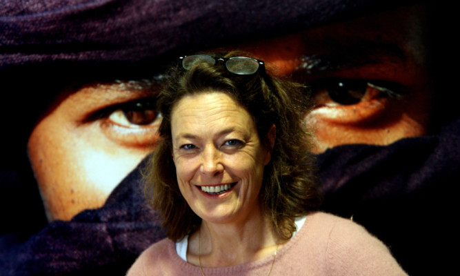 Photographer Henrietta Butler in front of one of her works.