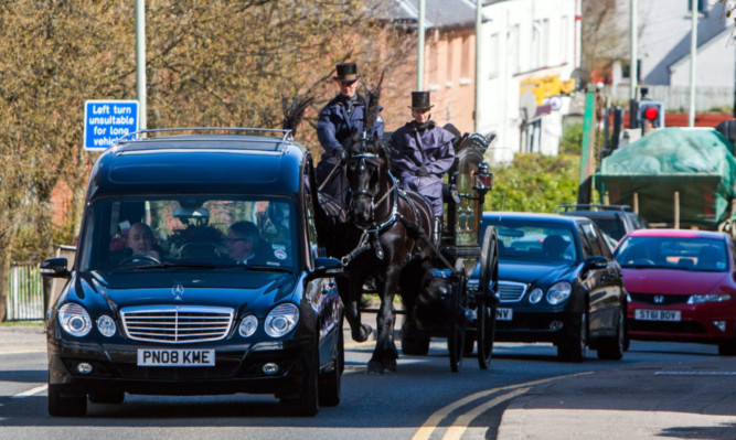 Megan's hearse is carried through Perth.