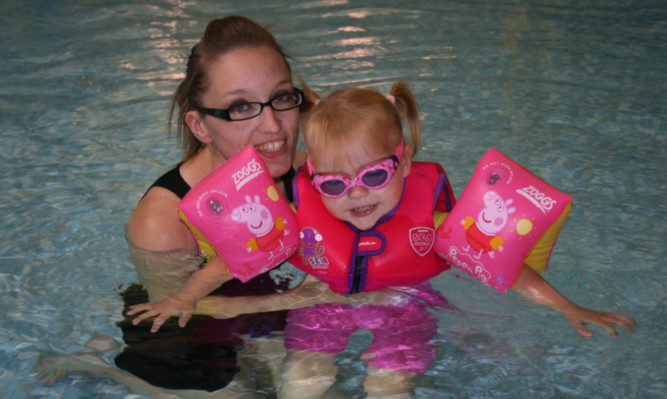 Debbie Munro and two-year-old Eire Meekison back swimming at the leisure centre.