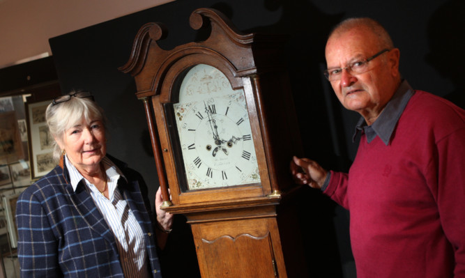 Dr Rheinheimer and wife Rita with the grandfather clock.