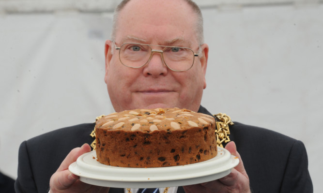 Lord Provost Bob Duncan with the winning entry in the Dundee cake competition.