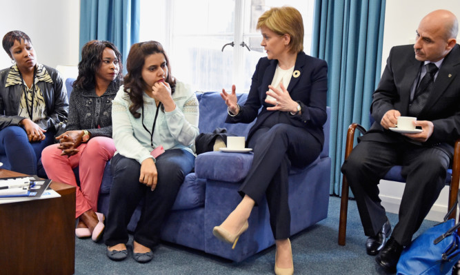 First Minister Nicola Sturgeon meets with representative from refugee community during a humanitarian summit at St Andrew's House  in Edinburgh.