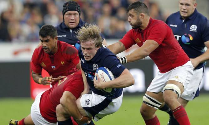 Jonny Gray is tackled by Frances Rabah Slimani, left, and Damien Chouly.