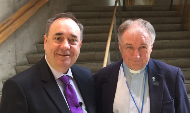 Alex Salmond, pictured with Rev Stuart MacQuarrie, has hit back after being criticised for revealing he prefers "people of faith to people of no faith or people who have lost their faith".