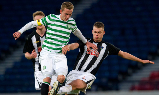 Dunfermlines Kerr Young  gets in a challenge on Celtics John Herron.