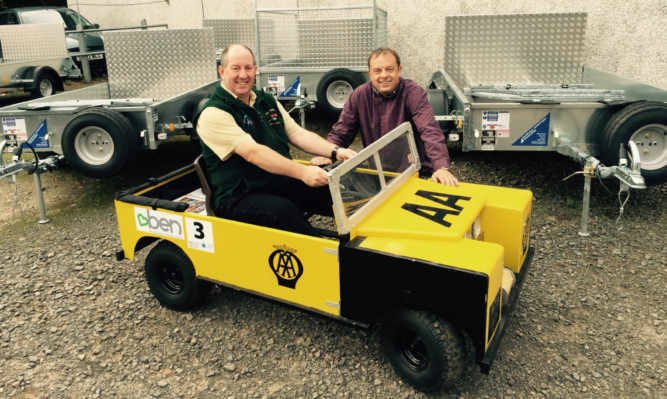 Paul Knowles of BRAVO Brechin with raffle winner James Arnott behind the wheel.