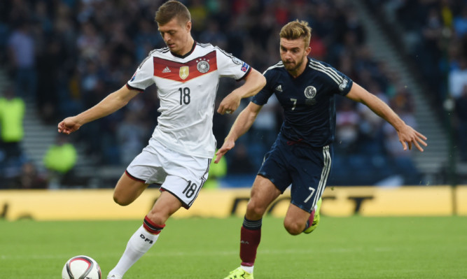 James Morrison (right) chases down Toni Kroos of Germany.