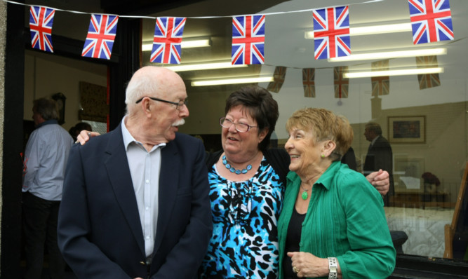 Ronnie and Frances Allan open the shop with Liz Dewar, centre, chairman of the trustees.