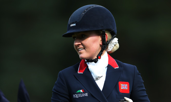 Holly Woodhead of Great Britain competes on DHI Lupison in the dressage.