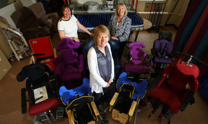 Sheila Dunphy (centre) of St Andrews Church Malawi Project with Angus Council joint equipment  loan service store manager Heather Thomson and Councillor Glennis Middleton.