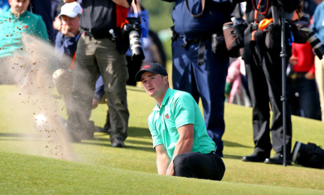 Paul Dunne plays out a bunker during GB&I's record Walker Cup game.