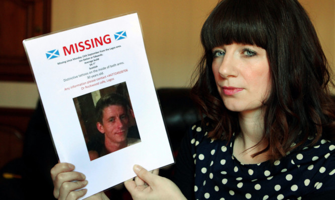 Kenna Balion with a poster of her brother Jon who went missing in Portugal in September last year.