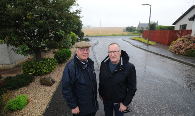 In Manor Gardens, Carnoustie, are residents Garry Cooper, left, and George McAteer who are highlighting objections to the plans for an anaerobic digester on scenic Westhaven Road, which would be sited in the field seen behind them.