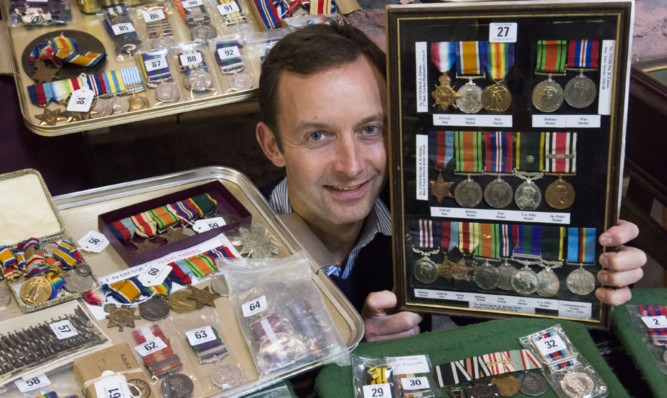 Steven Dewar with just some of the vast collection of military medals.
