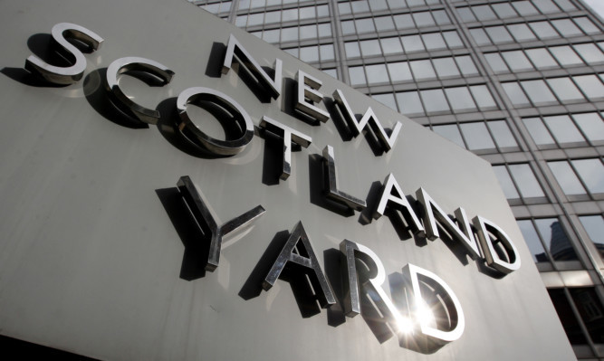 File photo dated 9/4/2009 of New Scotland Yard, the headquarters of the Metropolitan Police, in Westminster, London. The names of 42 dead children were used by undercover officers to create fake identities but their families have not been told because of the risk to police, a report said today. PRESS ASSOCIATION Photo. Issue date: Tuesday July 16, 2013. Derbyshire Chief Constable Mick Creedon, who is leading a probe into the activities of police moles, said that, while the relatives deserve an apology, revealing the names used "would and could put undercover officers at risk". See PA story POLICE Undercover. Photo credit should read: Dominic Lipinski/PA Wire