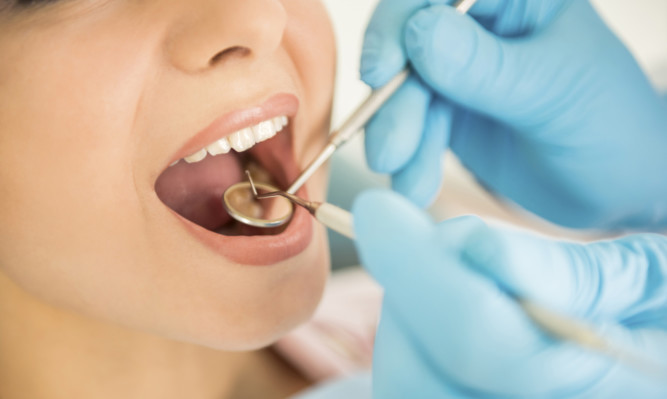 Dentist examining a patient's teeth in the dentist.