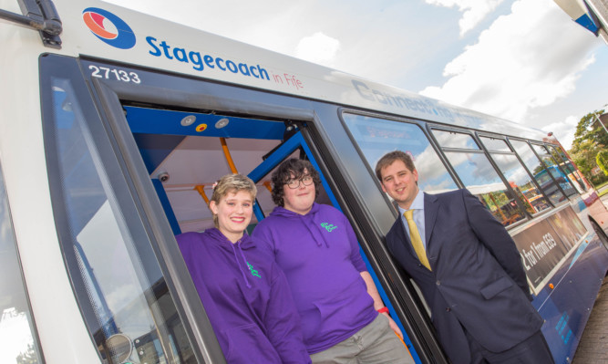 Fife Young Carers Samara King and Jake Leith with Stagecoach operations director Mark Whitelocks.