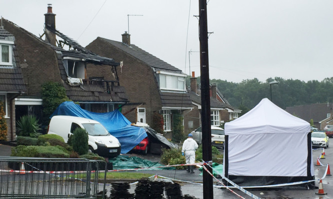 Forensic officers work at the scene at Valley View Road, Riddings, Derbyshire, after an explosion that killed Simon Saxton-Cooper and his wife Shelley.