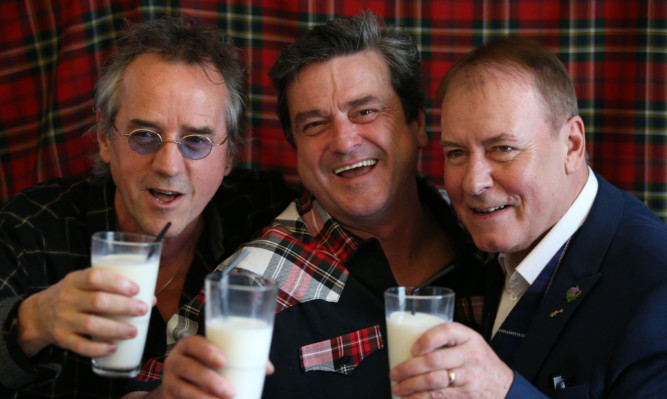 Bay City Rollers (left to right)  Stuart Wood, Les McKeown and Alan Longmuir toast with milk as they  make the announcement of their reunion at Central Hotel in Glasgow.