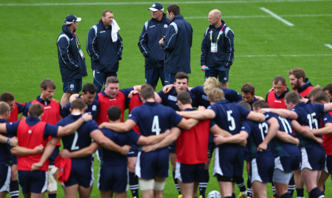 Vern Cotter (centre) and his assistants discuss matters at Scotland's final training session.