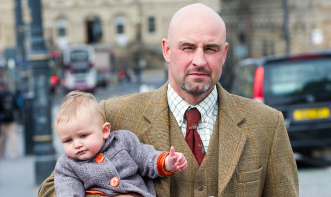 Glen Prosen gamekeeper Bruce Cooper with his 10-month-old daughter Jessica at the release of the grouse shooting film in Edinburgh.