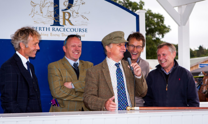 Sam Morshead at the mic during Wednesday's Clic Sargent Autumn Ladies Day. He is seen with legendary jockeys (from left) John Francome, Neale Doughty, Hywel Davies and Steve Smith Eccles.