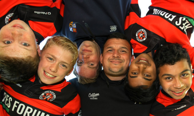 Phil Godman (third left) and Alan Brown (fourth left) with some of the young players.