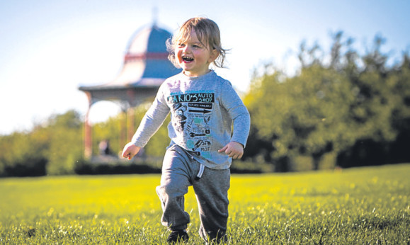 Toddler Sam Barrett enjoying the freedom to play in the sunshine at Magdalen Green.