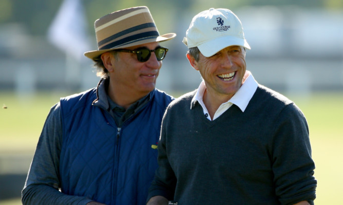 Hollywood actors Andy Garcia and Hugh Grant share a joke on the second tee at The Old Course in St Andrews.