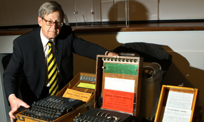 Dr Mark Baldwin with examples of code-breaking machines.