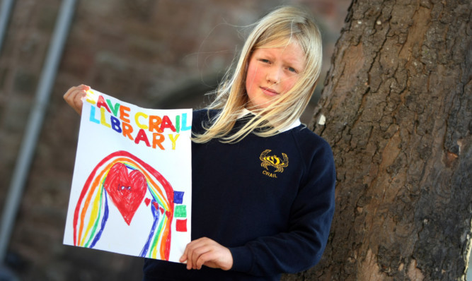 Crail Primary School pupil Attila Newey with her Save Crail Library poster.